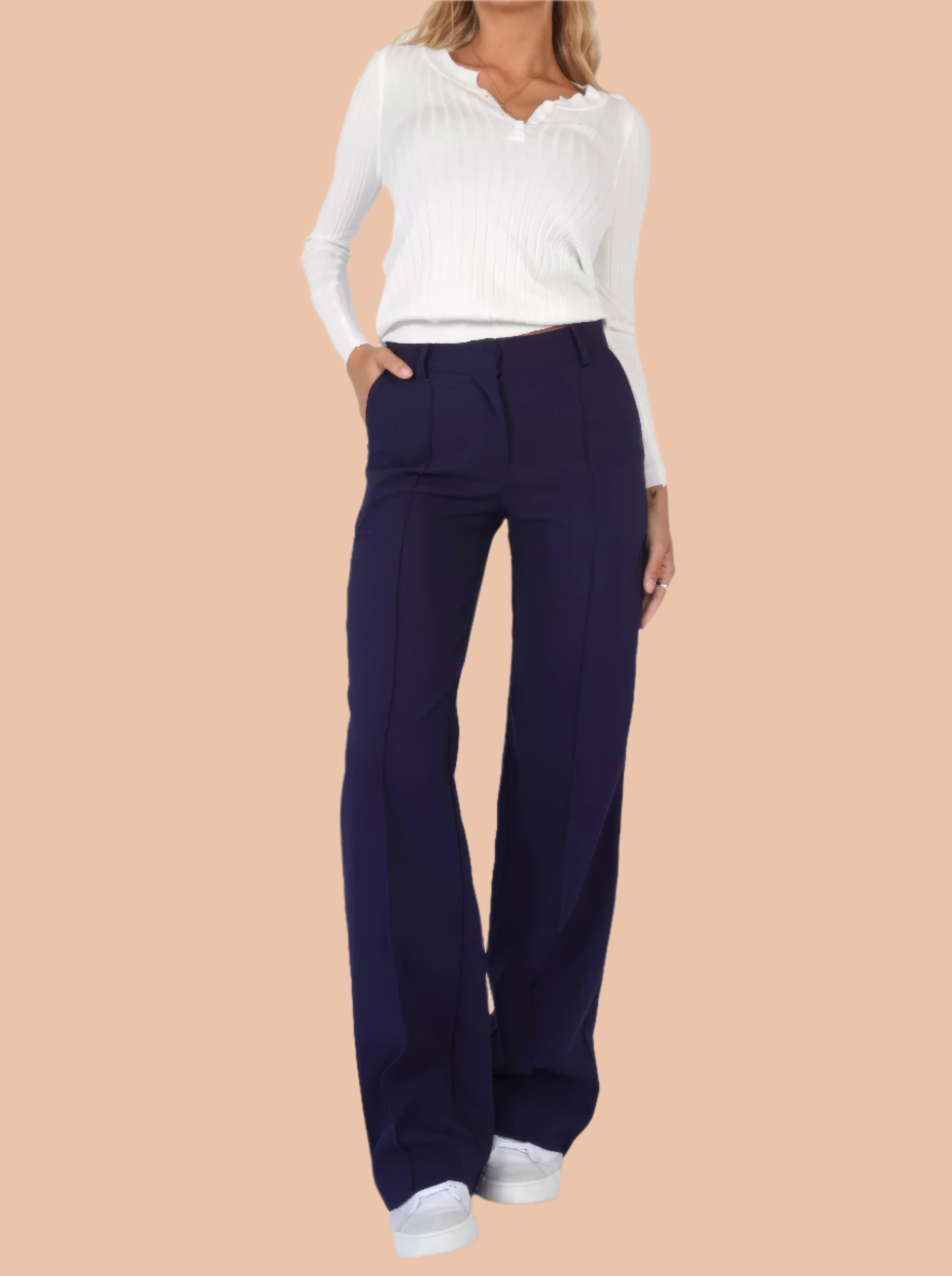 Navy blue high-waisted wide-leg trousers with front seam detailing and a clean waistband, paired with white sneakers for a modern smart-casual look.