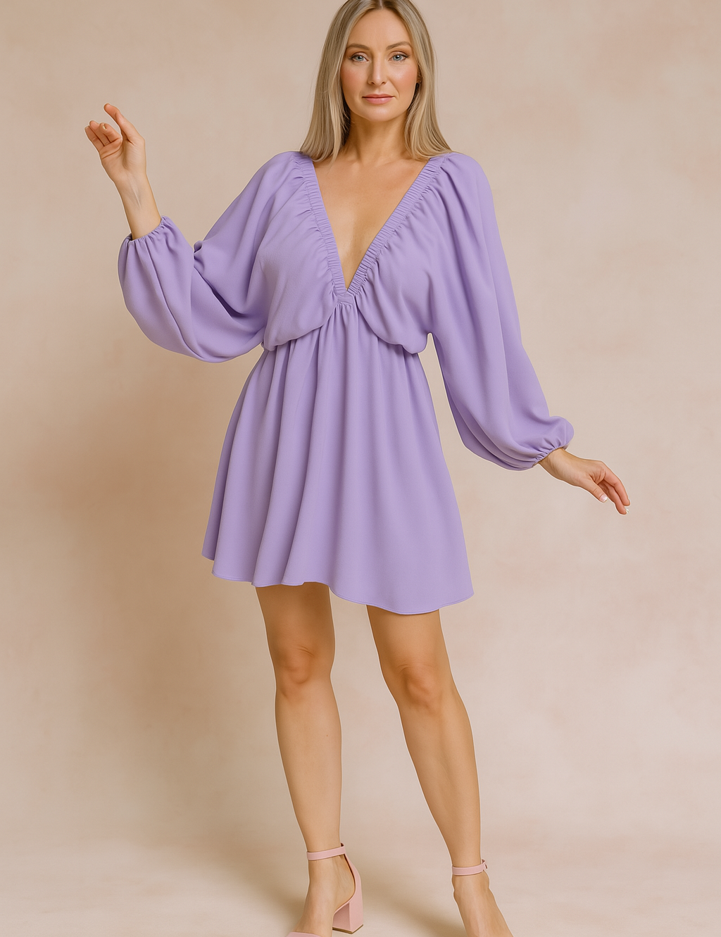 a lavender mini dress with bishop sleeves, posing against a soft sand and pastel pink background in a fashion shoot style.