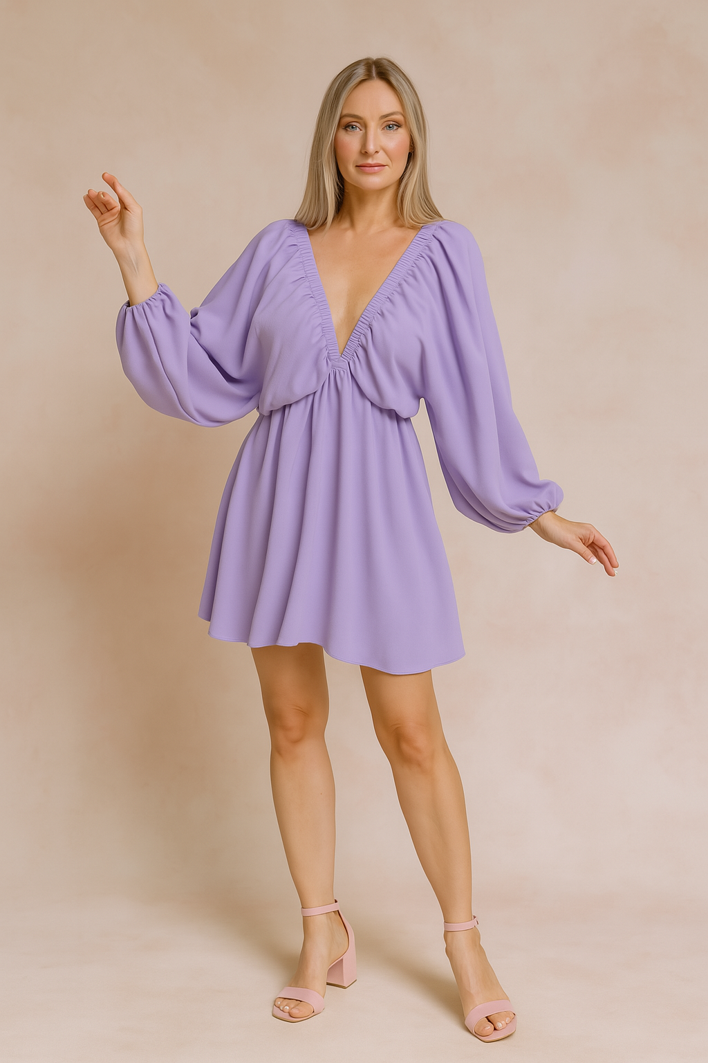 a lavender mini dress with bishop sleeves, posing against a soft sand and pastel pink background in a fashion shoot style.