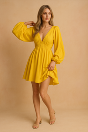 a yellow mini dress with bishop sleeves, posing against a soft sand and pastel pink background in a fashion shoot style.