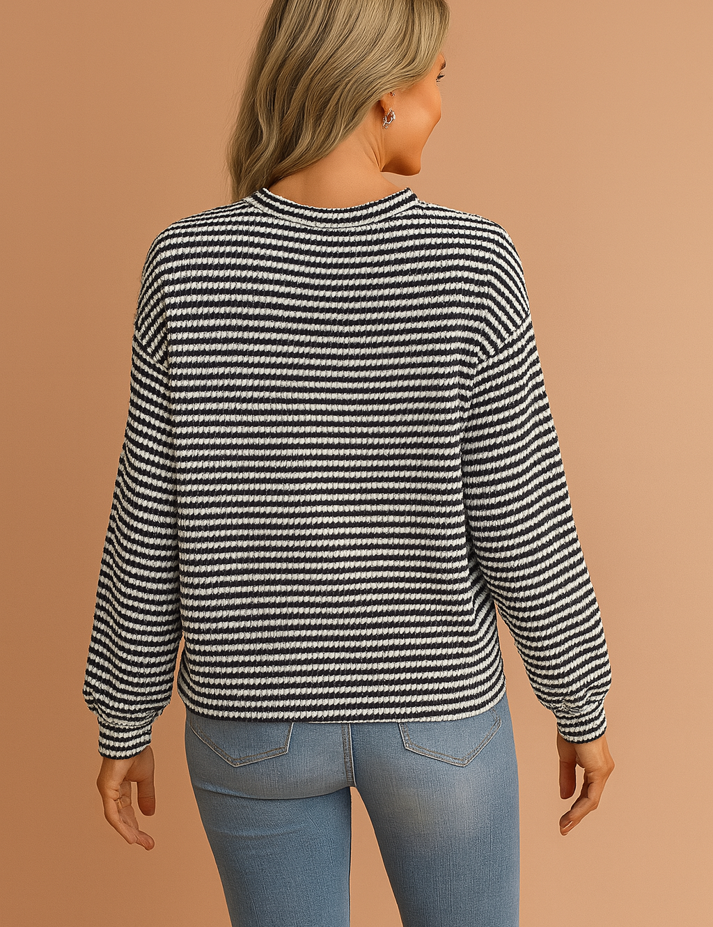 Black and white textured knit sweater with horizontal stripes, crew neckline, and relaxed fit paired with mid-rise light wash skinny jeans, accessorized with a tan suede clutch.