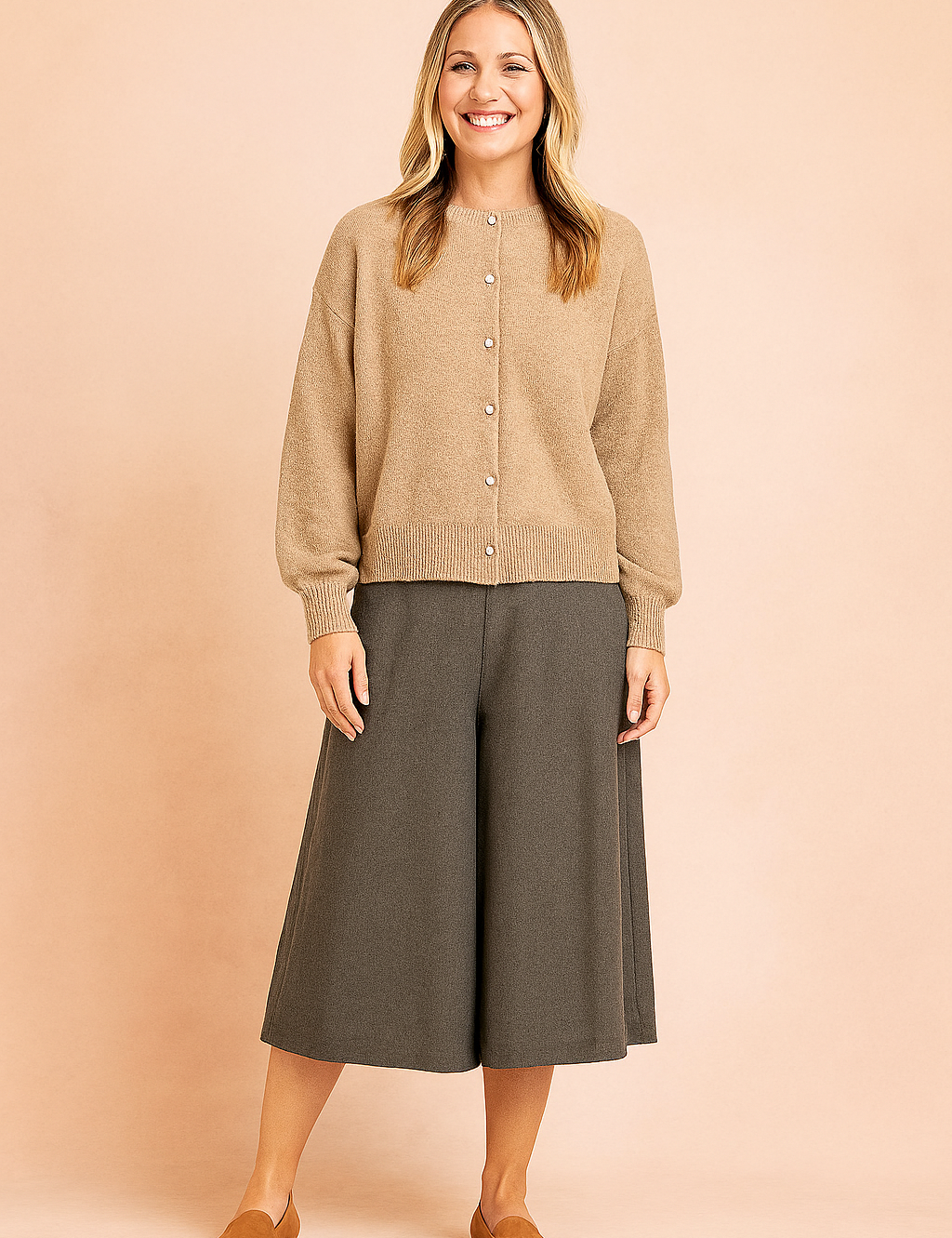 Heathered beige button-up cardigan with ribbed cuffs and hem, paired with wide-leg charcoal culottes and tan slip-on flats.