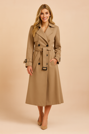 Elegant beige double-breasted trench coat with black buttons, belted waist, and sleeve buckle details, designed for a polished and timeless look.