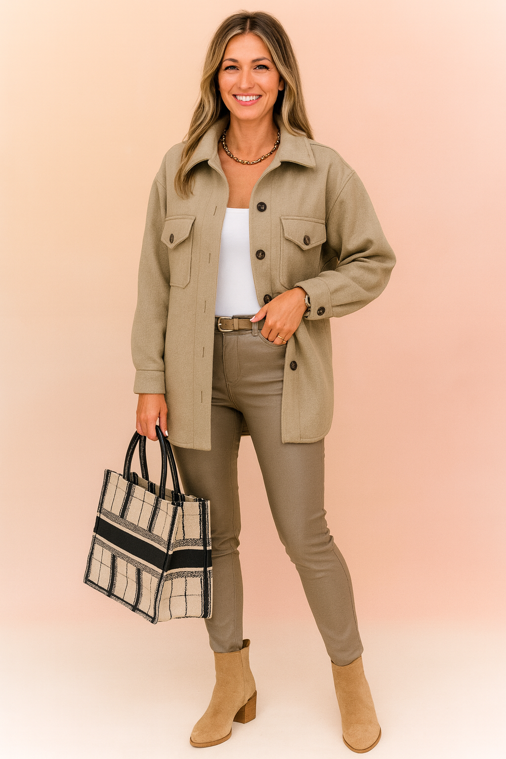 Beige button-up shacket jacket with front flap pockets, styled over a white top and slim-fit taupe pants, paired with a plaid structured tote bag and suede ankle boots.