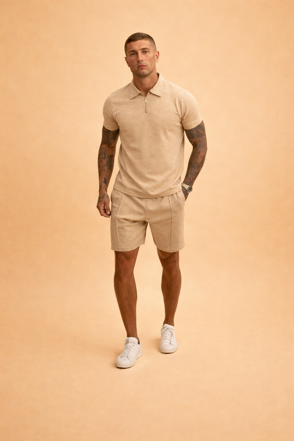 Textured beige short-sleeve zip polo shirt paired with matching tailored linen-blend shorts, featuring a clean minimalist cut, subtle woven fabric texture, tonal stitching, straight hem shorts, and coordinated warm sand color tones, styled with white low-profile sneakers for a refined summer set.