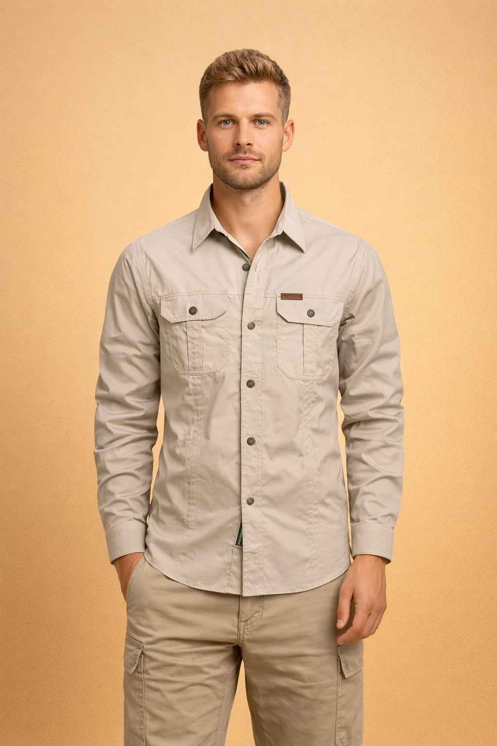 Beige long-sleeve button-up shirt with structured collar, front button closure, dual flap chest pockets with buttons, tailored straight fit, paired with beige cargo pants featuring side utility pockets and a clean modern cut