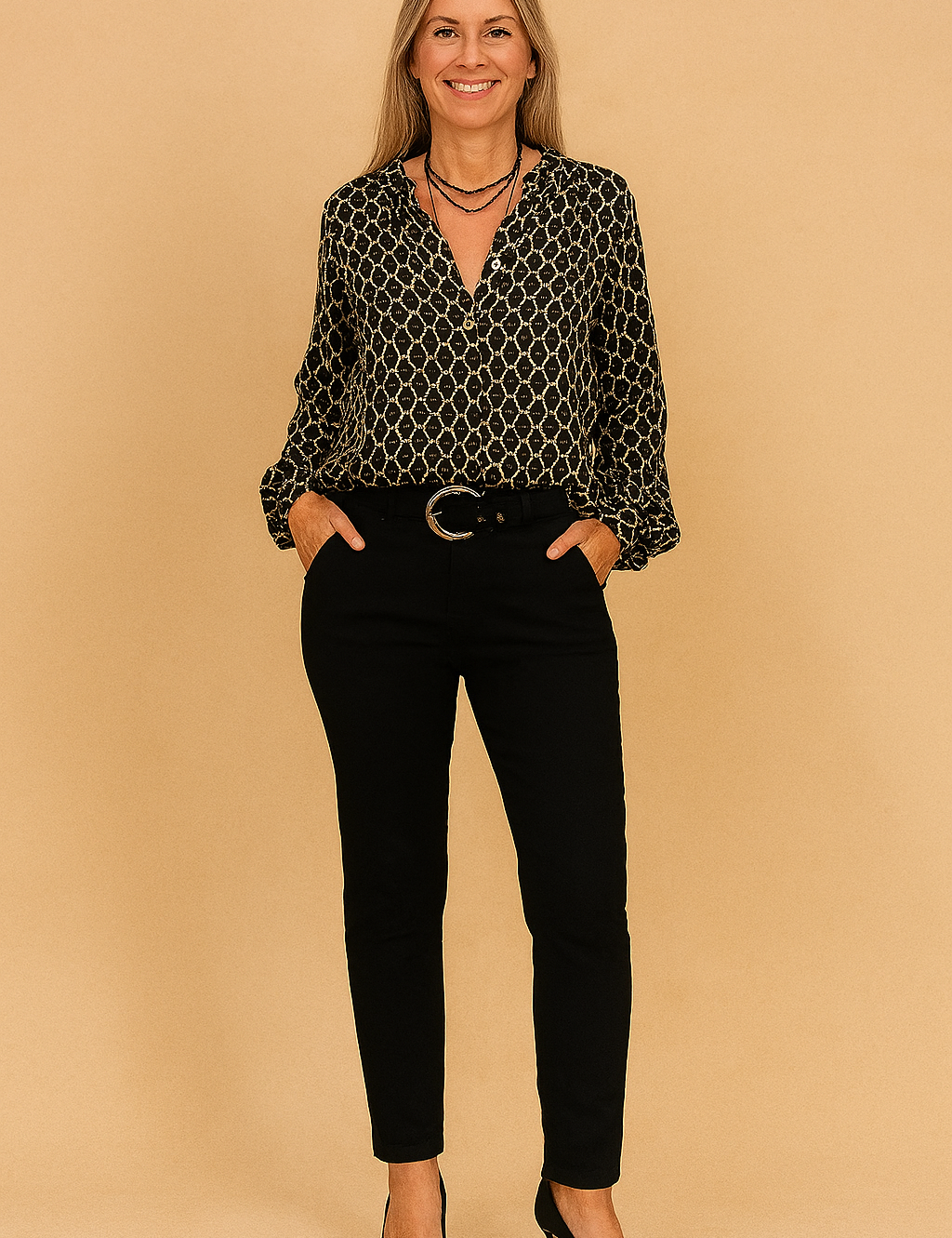 Black button-up blouse with beige geometric diamond print, paired with slim-fit black trousers and accessorized with a round buckle belt.