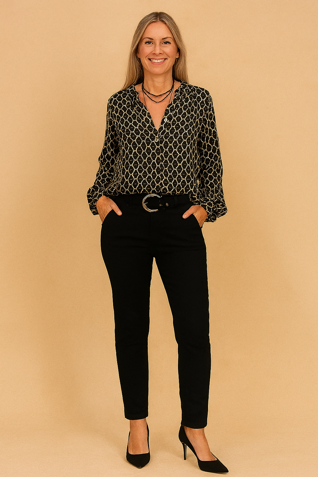 Black button-up blouse with beige geometric diamond print, paired with slim-fit black trousers and accessorized with a round buckle belt.