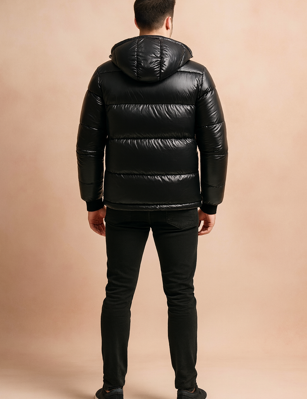Glossy black hooded puffer jacket with quilted padding, shown from the back to highlight stitching and fit.