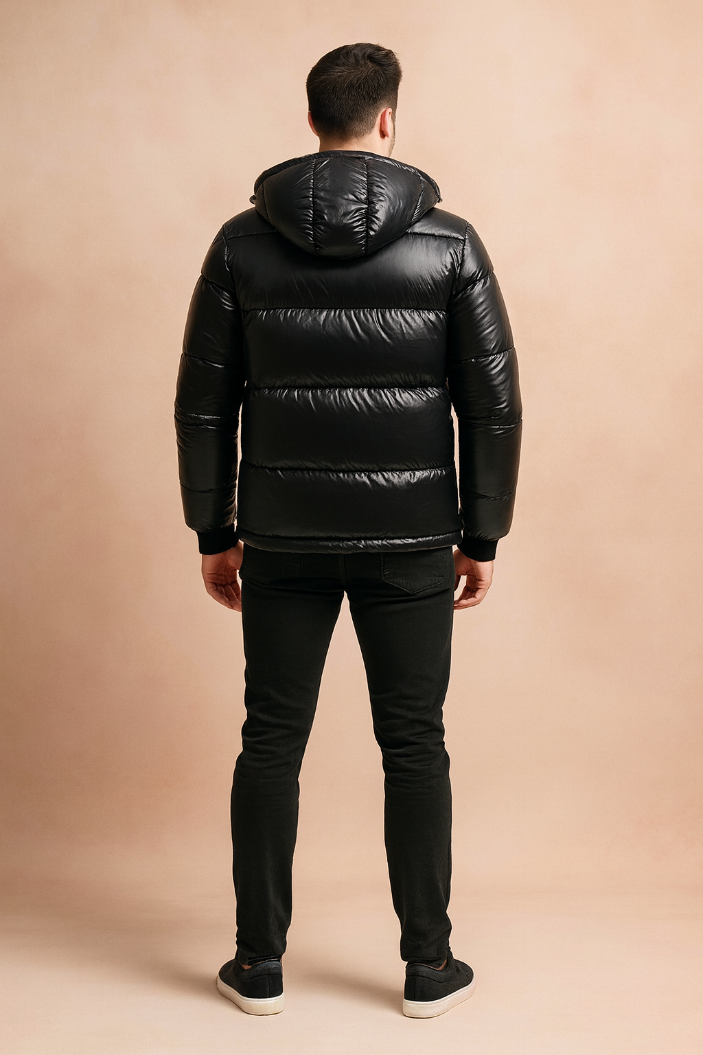 Glossy black hooded puffer jacket with quilted padding, shown from the back to highlight stitching and fit.