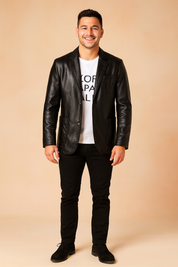 Black leather blazer jacket with button closure, front flap pockets, and sleek tailored finish, styled for a modern casual look.