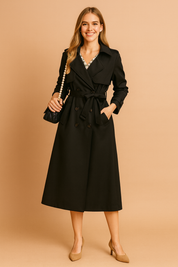 Black long trench coat with double-breasted button closure, belted waist, wide lapel collar, and side pockets, designed for a sleek and elegant outerwear look.
