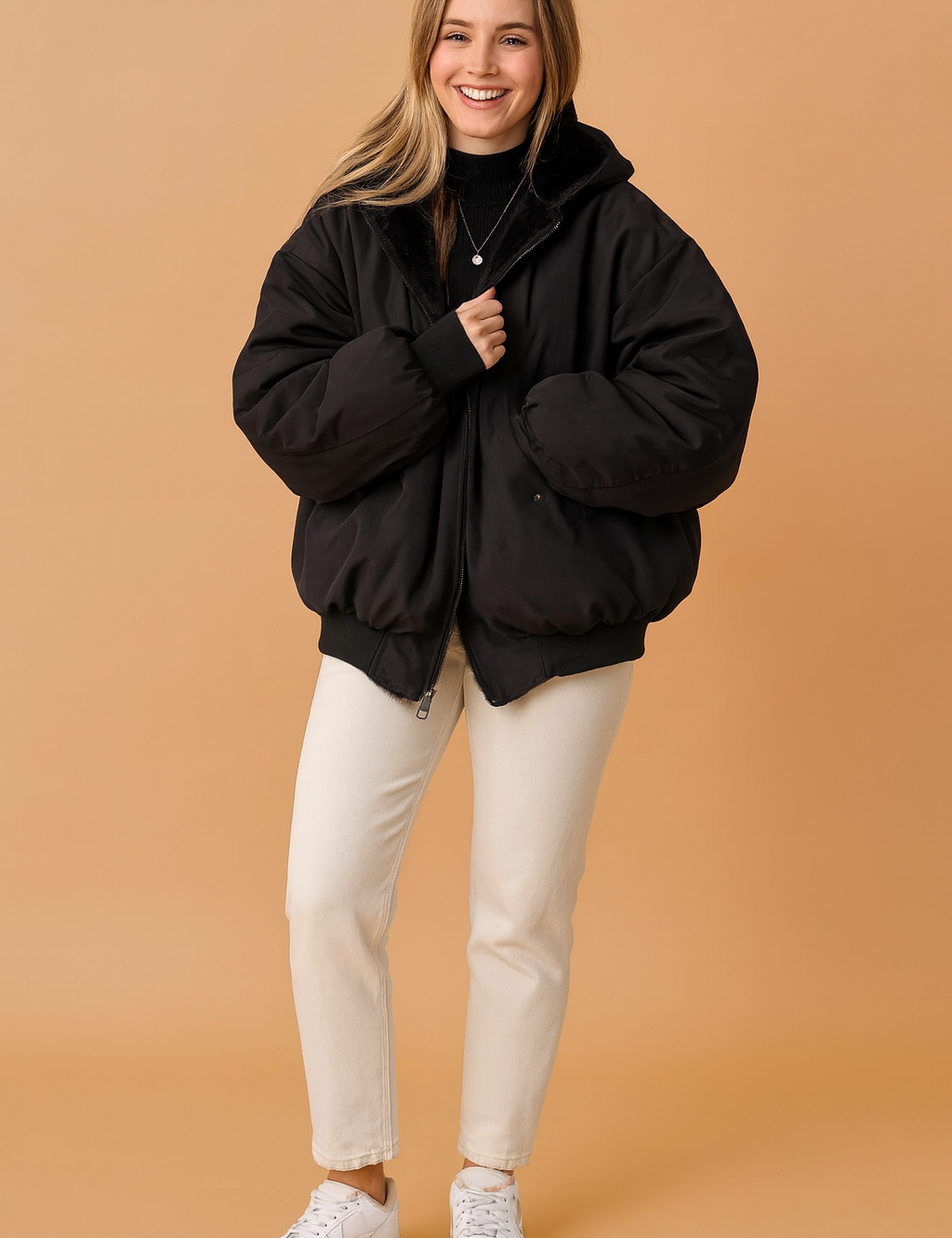 Black oversized zip-up jacket with fur lining, paired with a black turtleneck, off-white straight-leg pants, and white sneakers for a cozy winter look.