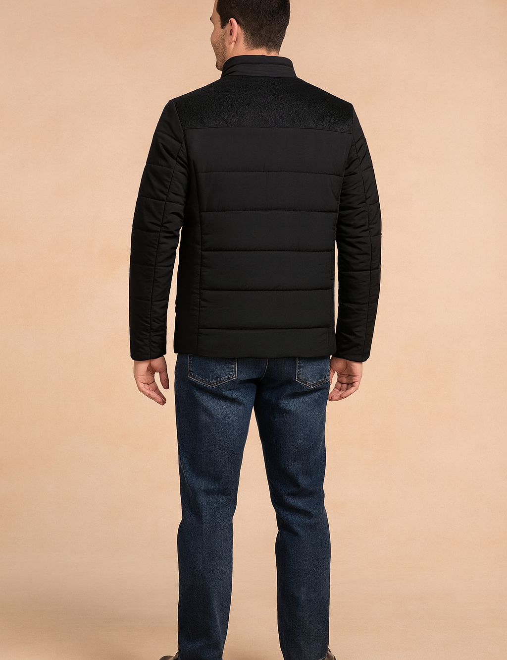 Black padded men's jacket with textured shoulder panel and horizontal quilted stitching, shown from the back.