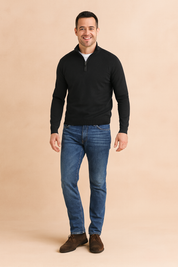 Black quarter-zip sweater with a ribbed texture, styled over a white undershirt, paired with blue jeans for a smart casual look.