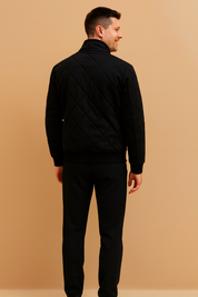 Black quilted men’s jacket with diamond-stitched pattern, ribbed cuffs and hem, and a sleek modern cut designed for casual and semi-formal wear.