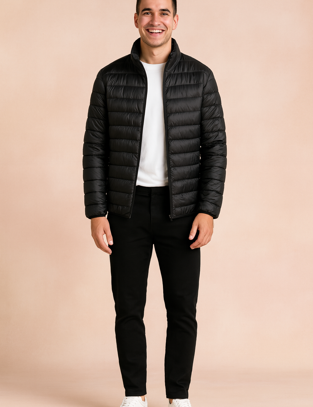 Black puffer jacket with horizontal quilted design and front zipper, styled with a white t-shirt, black trousers, and white sneakers.