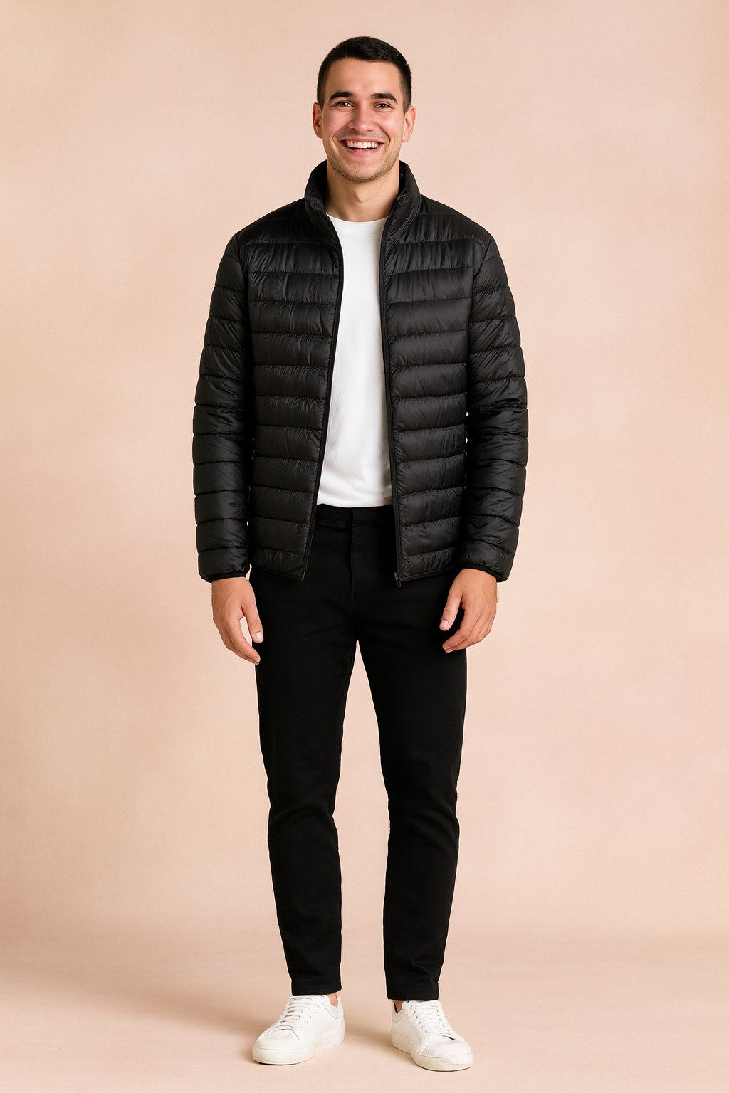 Black puffer jacket with horizontal quilted design and front zipper, styled with a white t-shirt, black trousers, and white sneakers.