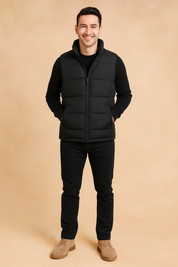 Men’s black quilted puffer vest with zip closure and dual zip pockets, featuring a sleek, lightweight design ideal for layering in cold weather.