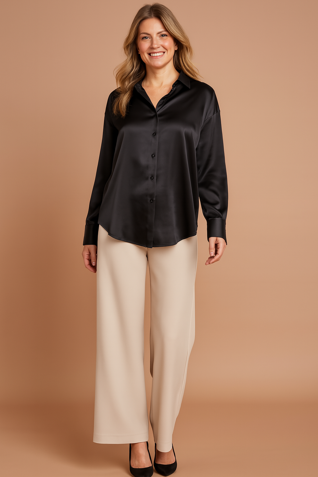 Oversized black satin button-up blouse with a pointed collar, long sleeves, wide cuffs, and a smooth glossy finish.