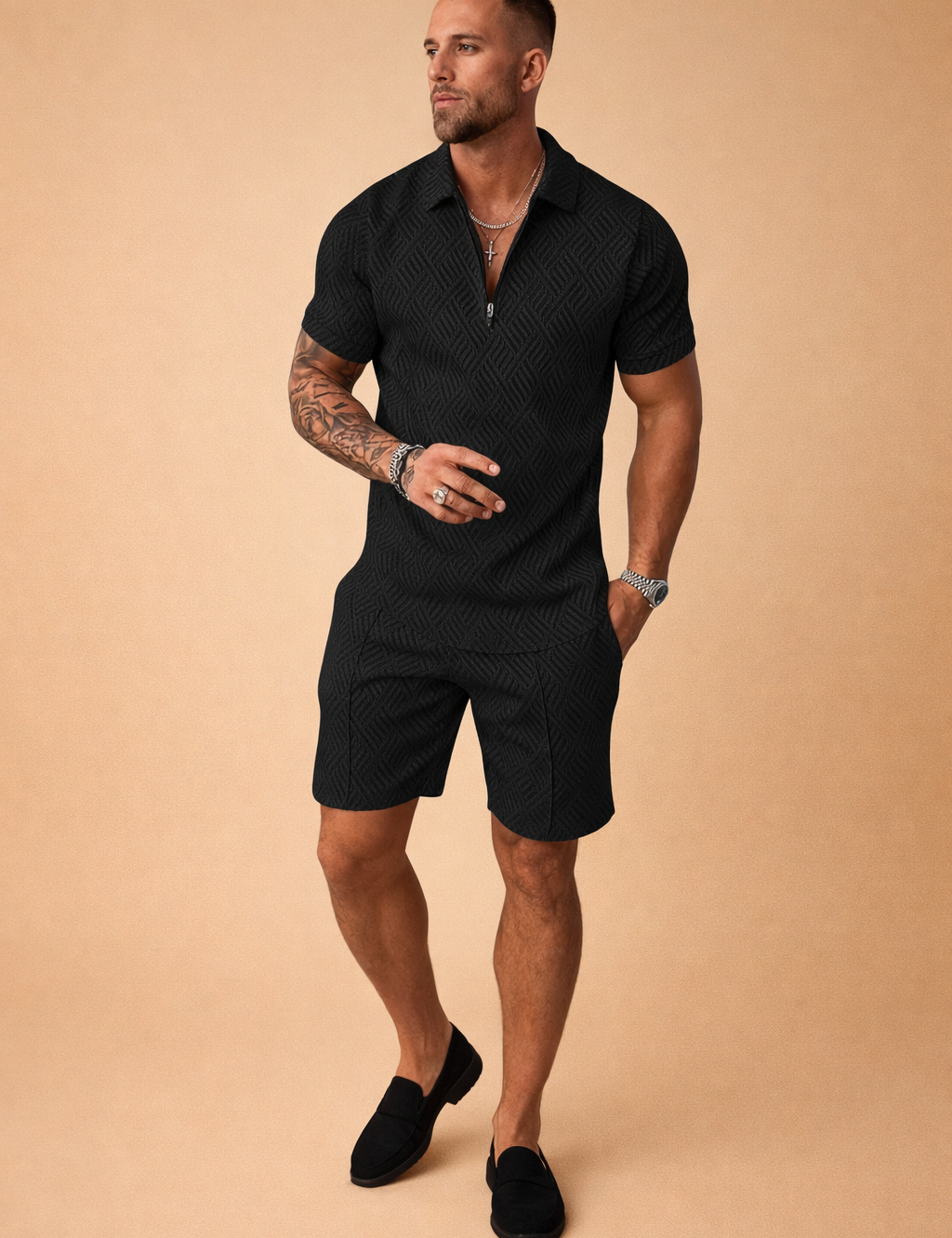 Black two-piece men’s summer outfit featuring a textured short-sleeve zip-neck polo shirt with geometric woven pattern, paired with matching tailored black shorts in the same structured fabric for a coordinated modern look.