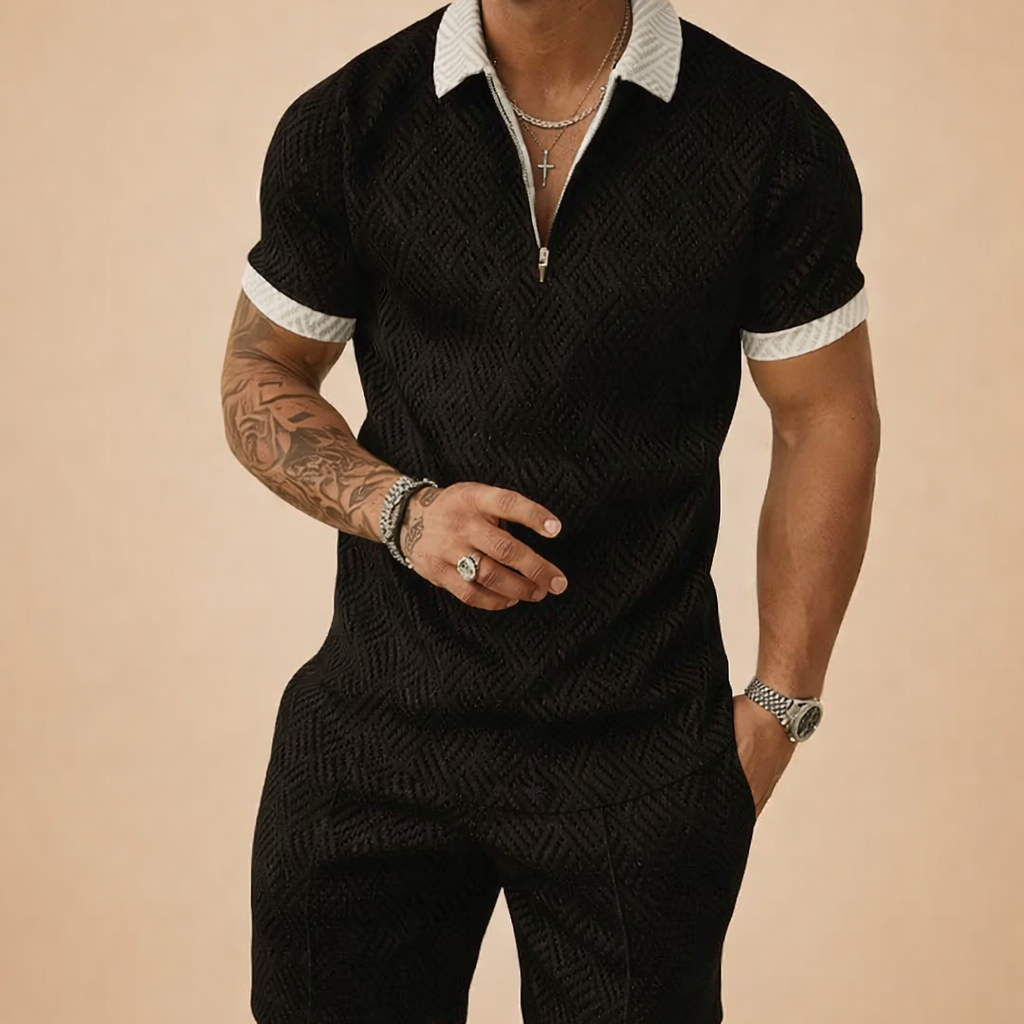Black short-sleeve textured zip polo with a subtle geometric pattern, finished with a white contrast collar and sleeve cuffs, paired with matching tailored shorts for a coordinated summer set.