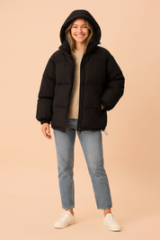 Black unisex puffer jacket with hood, front zipper closure, side pockets, and elastic cuffs, designed for winter warmth and comfort