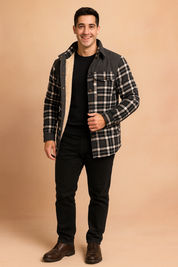 Black and white plaid fleece-lined flannel jacket with button-up closure, chest flap pockets, and long sleeves for a casual winter style.
