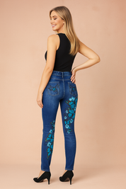 High-rise blue skinny jeans with striking blue butterfly and floral embroidery, featuring detailed stitching and a sleek fitted silhouette.