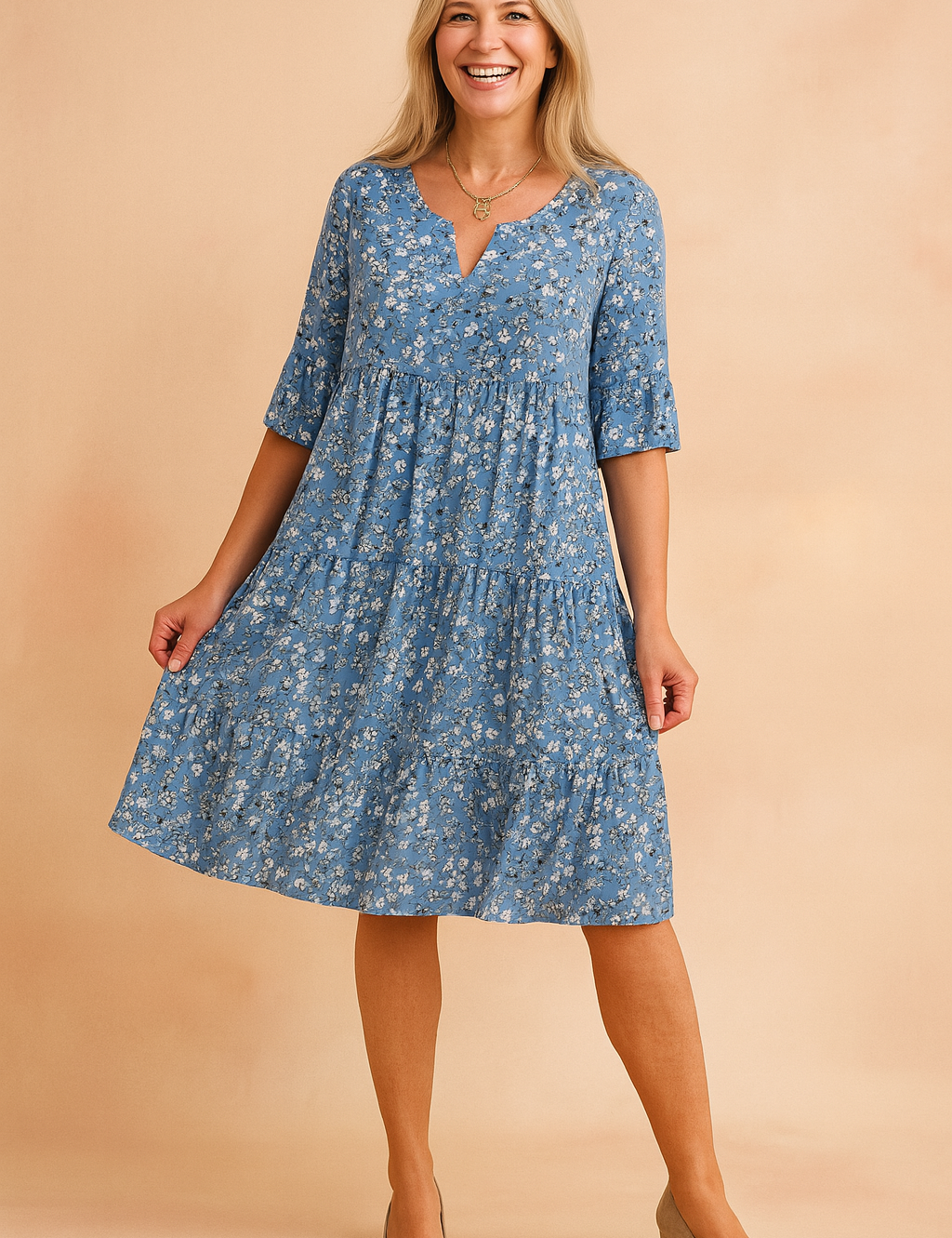 Flowy blue floral V-neck dress with half sleeves and tiered skirt, featuring an all-over daisy print in white and muted blue-gray tones, designed for a relaxed, breezy silhouette with precise seam detailing.