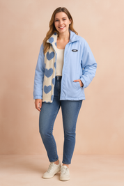 Light blue winter jacket with cream fleece lining decorated with blue heart patterns, zip closure, side pockets, styled with slim-fit blue jeans and off-white