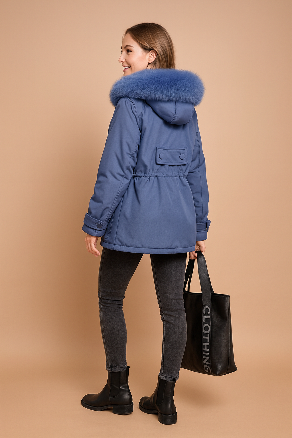 Slate blue hooded parka with plush faux fur trim, belted back detail, adjustable cuffs, paired with slim dark grey leggings and black ankle boots, styled with a black Burberry tote bag.