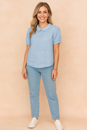 Powder blue linen blouse with Peter Pan collar and short puff sleeves, styled with light-wash jeans and white sneakers.