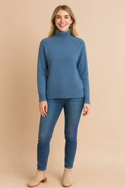 Blue high-neck ribbed knit sweater paired with slim-fit blue jeans and beige ankle boots, designed for a cozy and stylish casual look.