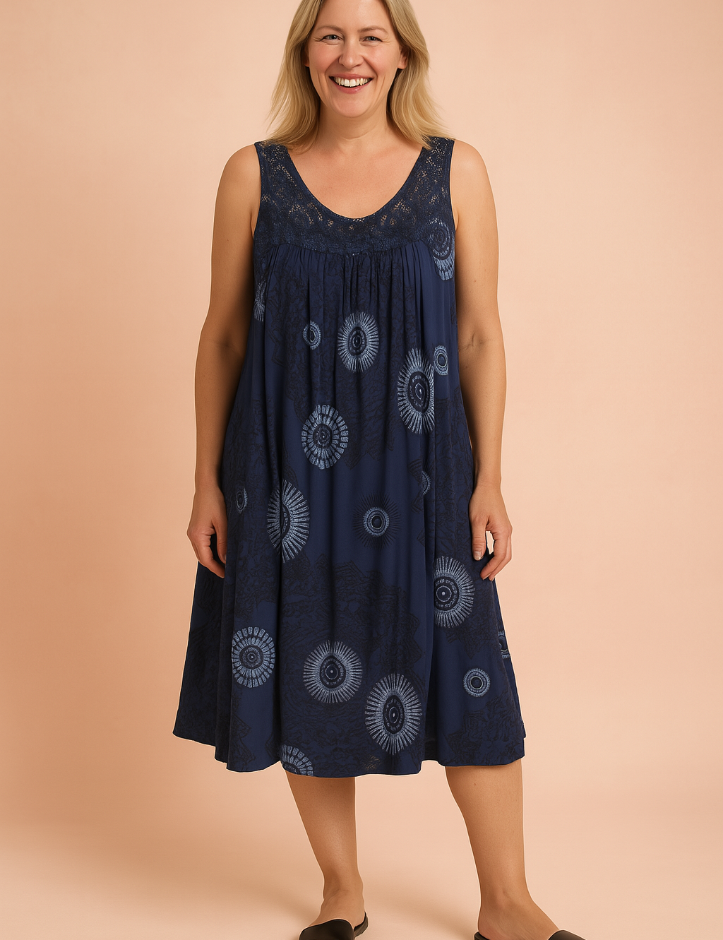 Sleeveless navy blue bohemian sundress featuring intricate circular tribal patterns and a lace-detailed neckline, flowing into a loose, knee-length silhouette perfect for relaxed summer styling.