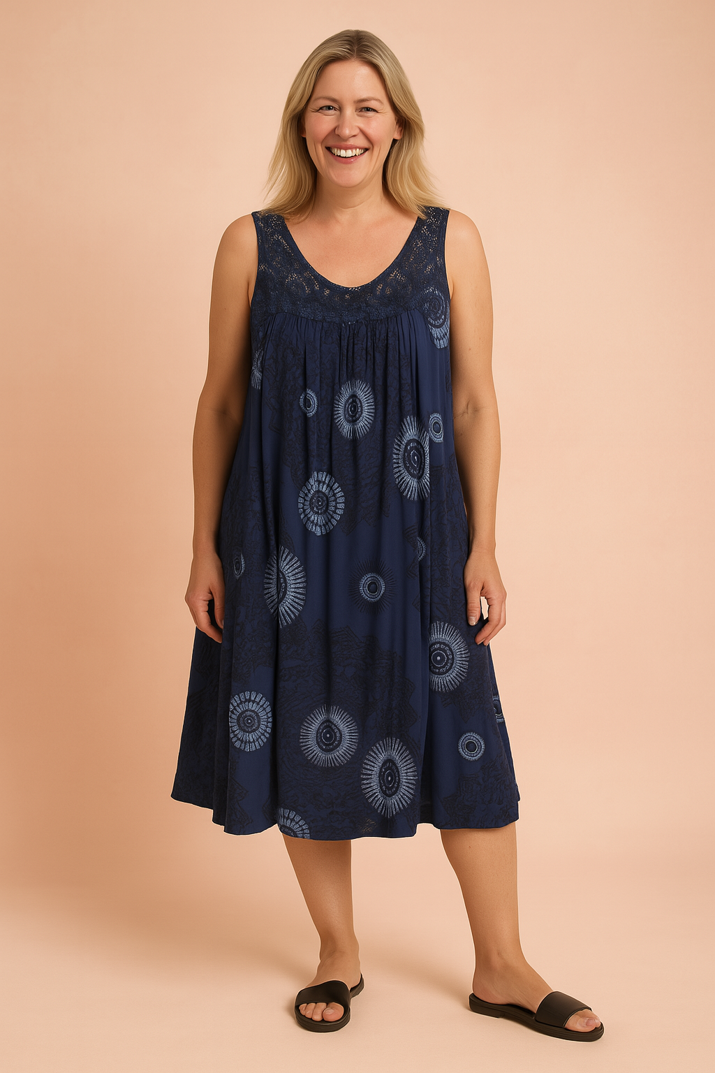 Sleeveless navy blue bohemian sundress featuring intricate circular tribal patterns and a lace-detailed neckline, flowing into a loose, knee-length silhouette perfect for relaxed summer styling.