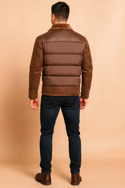 Brown bomber-style winter jacket with padded quilted panels, distressed leather sleeves and shoulders, and a soft faux fur collar, shown from the back to highlight the stitching and texture details.
