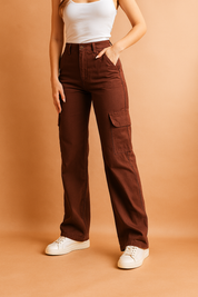 Chocolate-brown high-waisted cargo pants with flap side pockets and straight leg cut, styled with white sneakers.