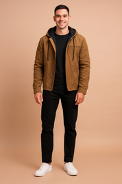 Brown hooded jacket with black fleece lining, front zipper and drawstring details, styled with black trousers and white sneakers.