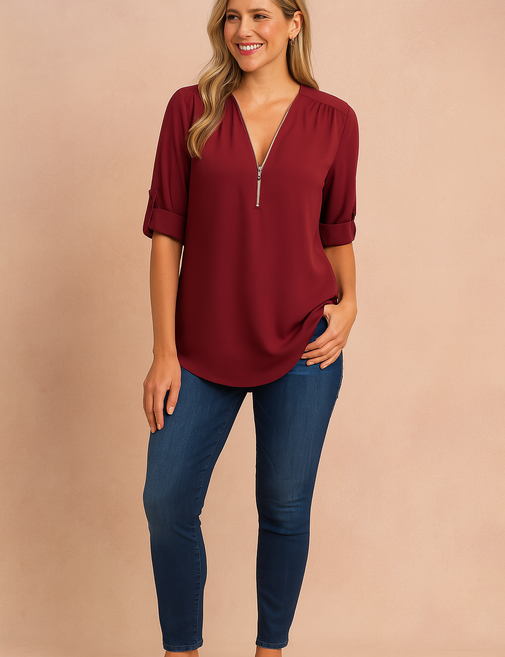Elegant burgundy zip-up blouse with rolled-up sleeves, styled with dark blue skinny jeans and tan block-heel sandals for a classic, polished look.