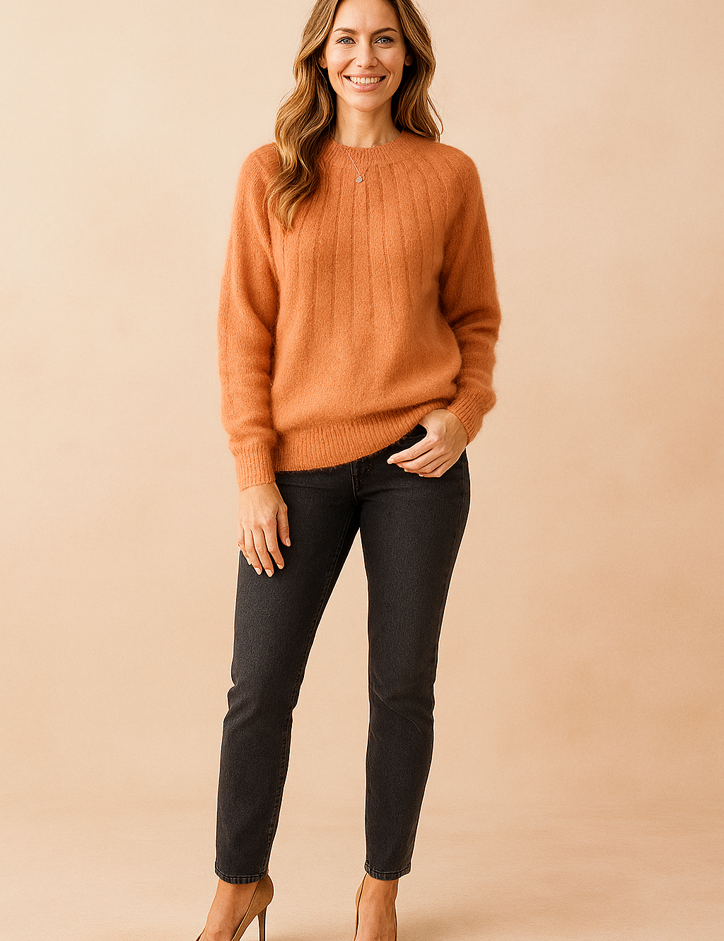 Burnt-orange ribbed fuzzy sweater paired with dark grey slim-fit jeans and tan suede pumps.