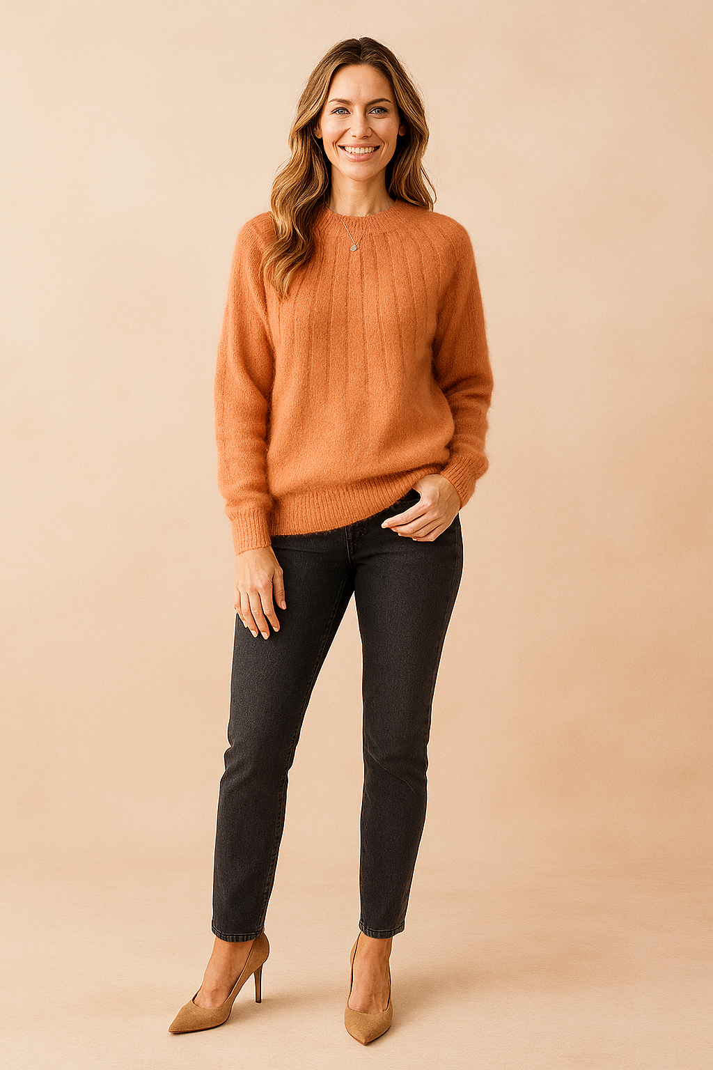 Burnt-orange ribbed fuzzy sweater paired with dark grey slim-fit jeans and tan suede pumps.