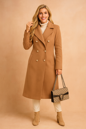 Double-breasted long trench coat with pearl-style buttons, tailored fit, structured lapels, and elegant detailing for a refined winter look.