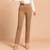 High-waisted camel straight-leg trousers with clean lines and minimal detailing, styled with a white blouse and neutral heels for a polished, professional look.