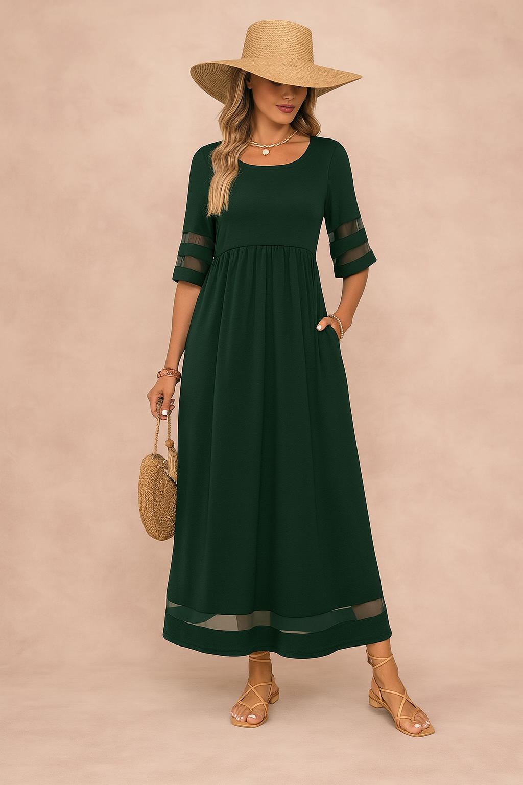 Kobieta w zielonej eleganckiej sukience maxi CAMOGLI z półprzezroczystymi rękawami – stylowy i wygodny wybór na każdą okazję.