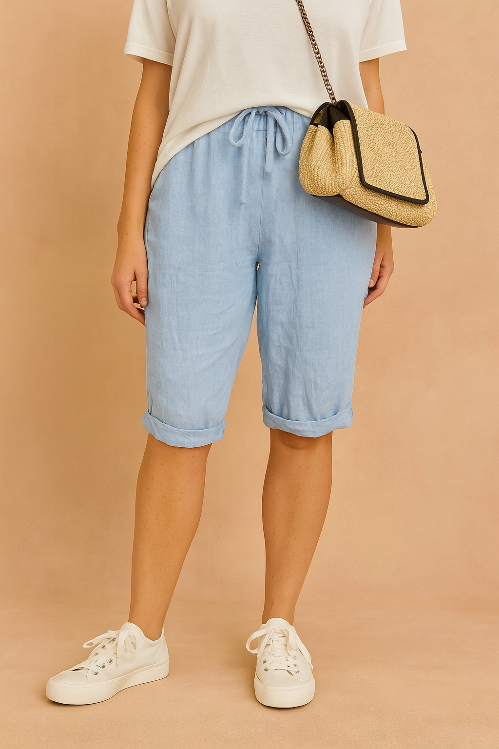 Light blue knee-length drawstring shorts with rolled cuffs, styled with a casual white T-shirt and white lace-up sneakers.
