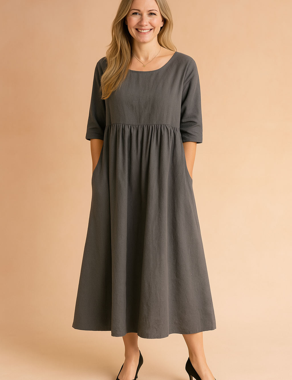 Charcoal gray linen midi dress with elbow-length sleeves, a gathered empire waistline, and side pockets, styled for a casual yet refined look.