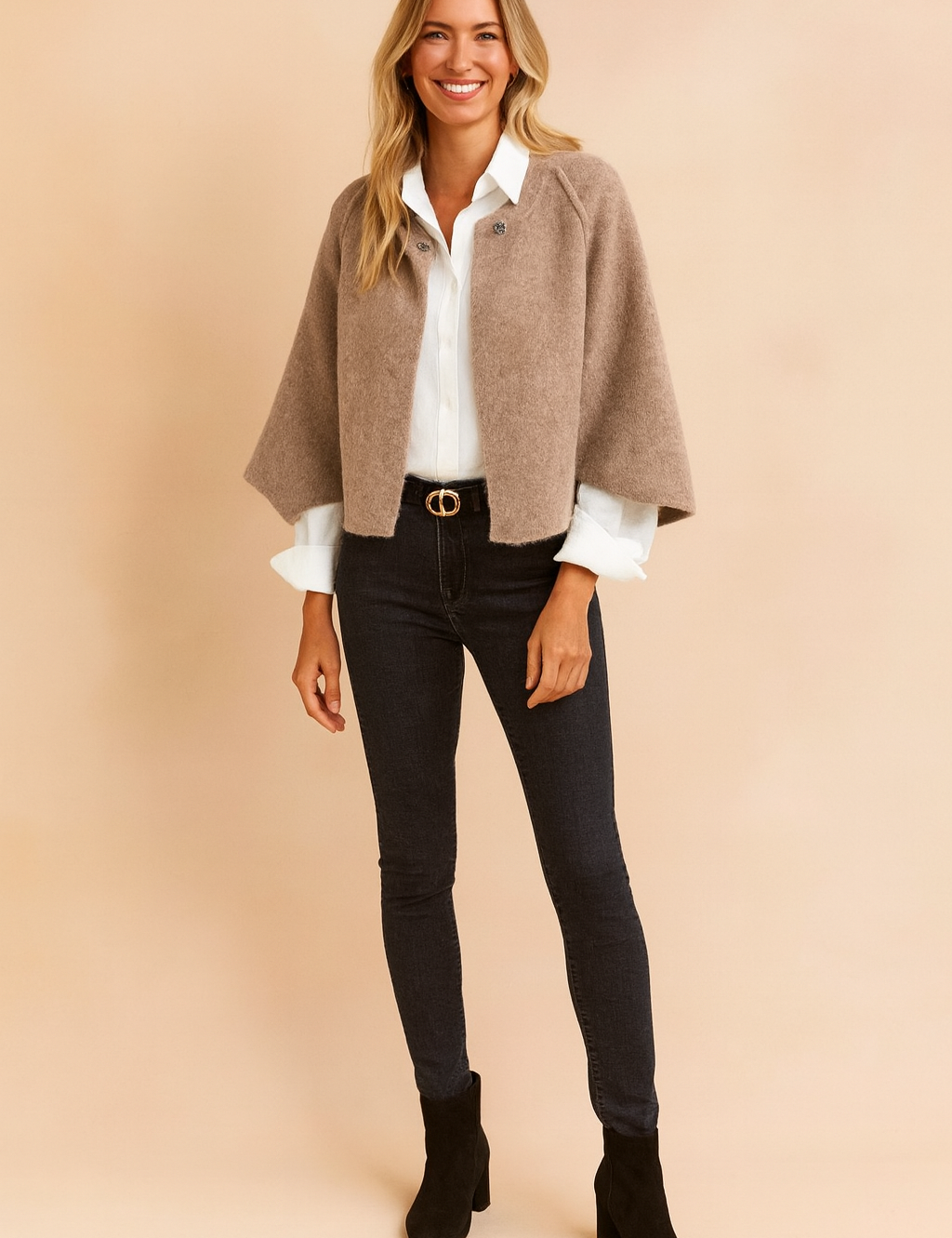  Beige cropped cardigan with a soft, textured finish, worn over a crisp white button-down shirt, paired with high-waisted dark skinny jeans and black suede ankle boots.