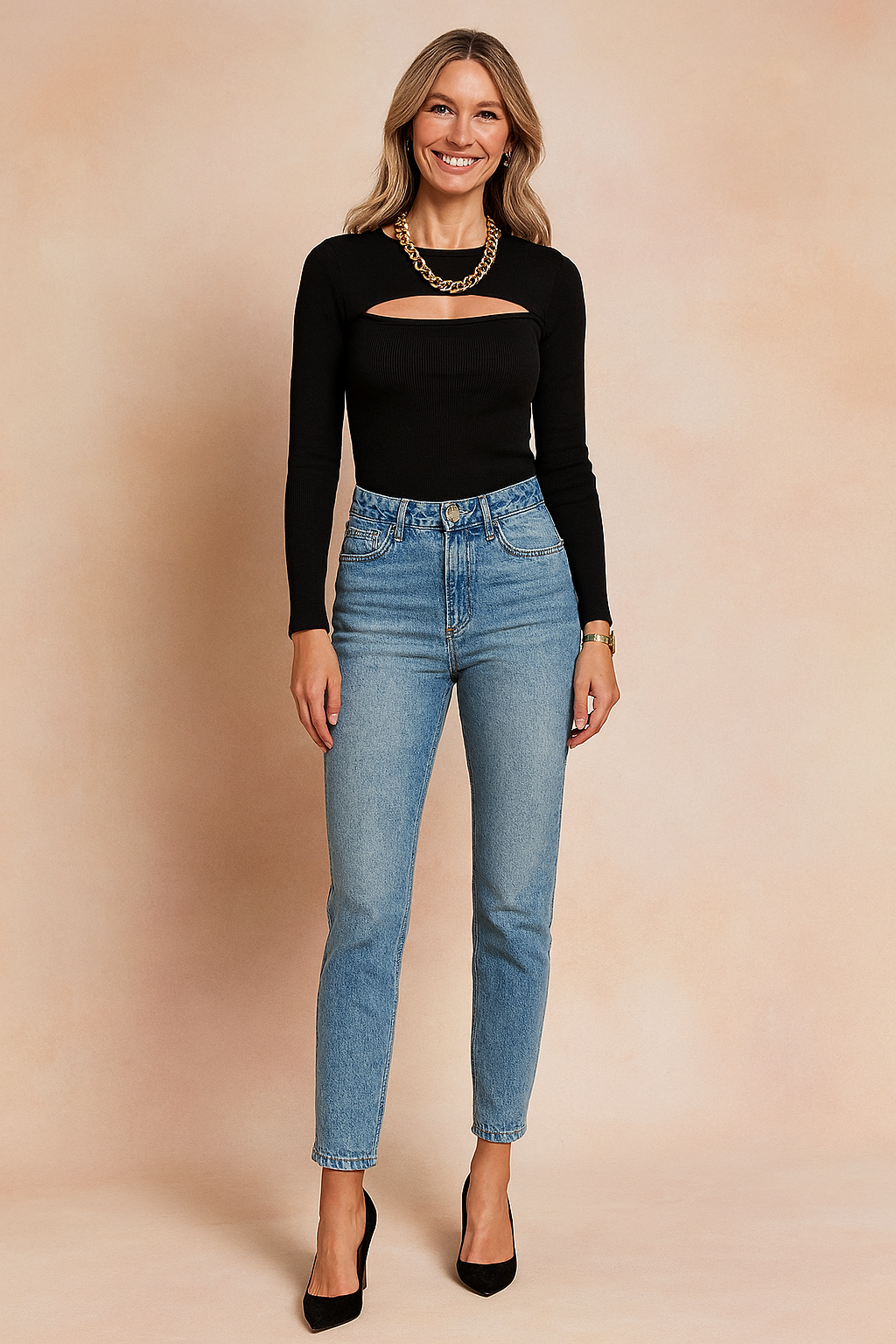 Black ribbed long-sleeve cutout top paired with high-waisted light blue jeans and black pointed-toe pumps, accessorized with a chunky gold chain necklace.