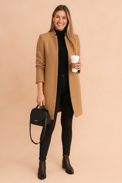 Elegant camel longline coat over a fitted black turtleneck, paired with slim black jeans, sleek black ankle boots, and a structured black leather handbag.